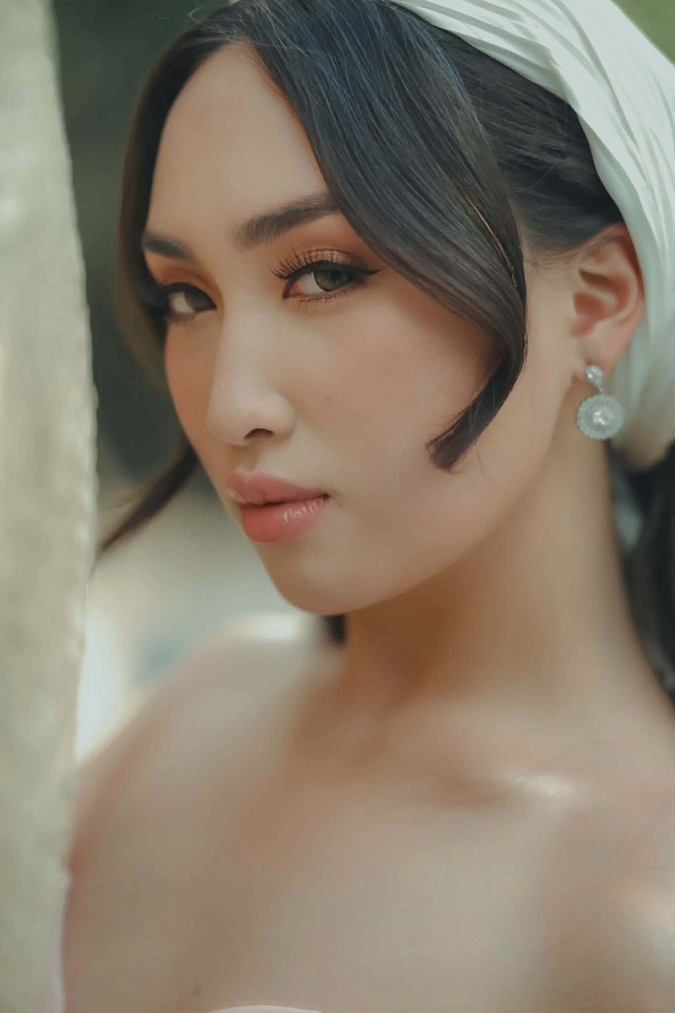 Shamira Amber in a pearl scarf, looking into the camera
